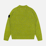 A back view of the green Maglia Speck Crewneck Sweater by STONE ISLAND, featuring a knit design with long sleeves, ribbed cuffs, and hem. A black logo patch is attached to the upper left sleeve. The background is plain light grey.