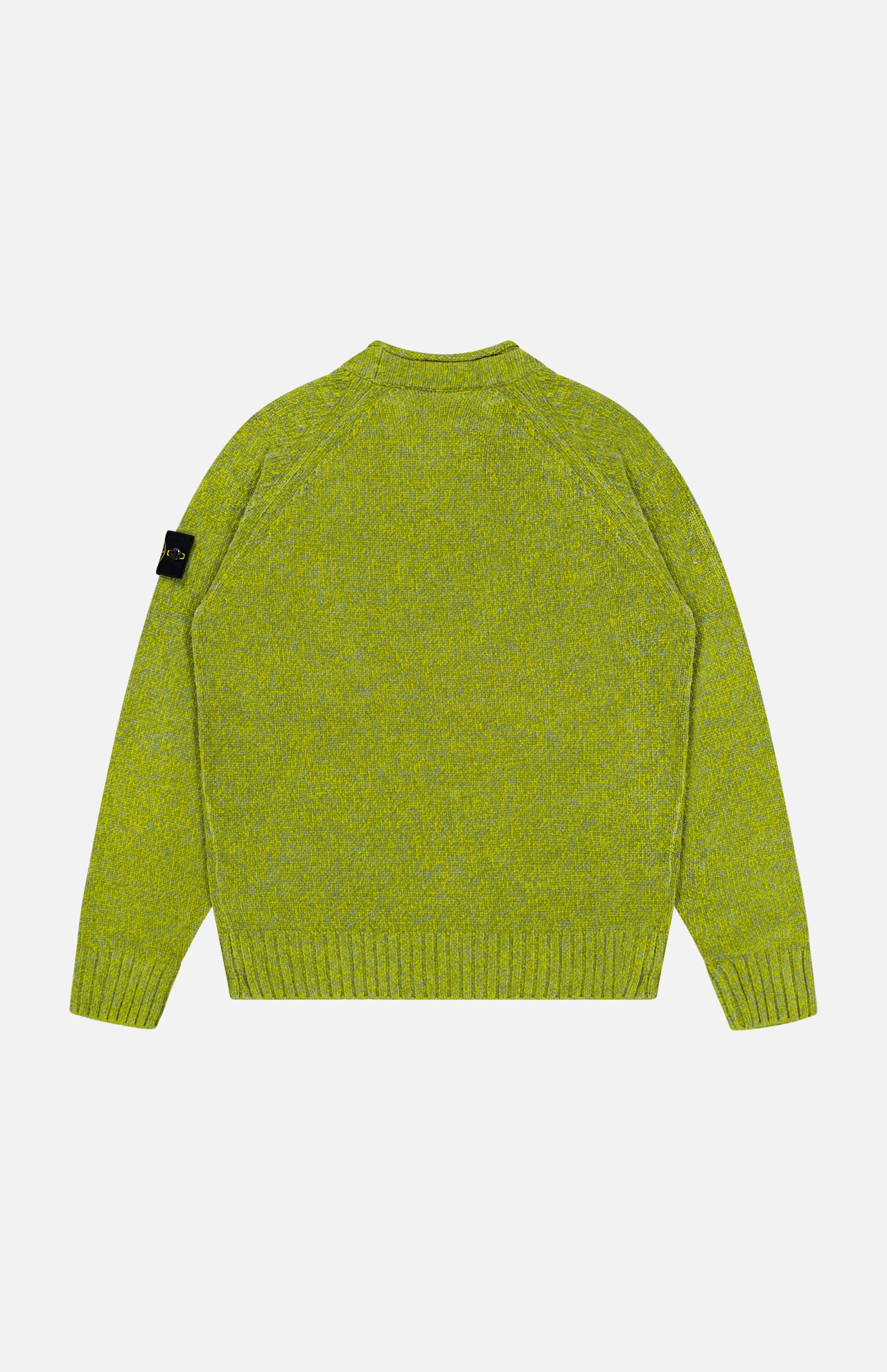 A back view of the green Maglia Speck Crewneck Sweater by STONE ISLAND, featuring a knit design with long sleeves, ribbed cuffs, and hem. A black logo patch is attached to the upper left sleeve. The background is plain light grey.