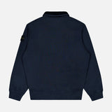 A STONE ISLAND Quarter Zip Sweatshirt in navy blue is displayed from the back, showcasing its long sleeves with ribbed cuffs and hem. The left sleeve features a small black patch with a yellow logo. Set against a plain white background, this sportswear staple stands out.