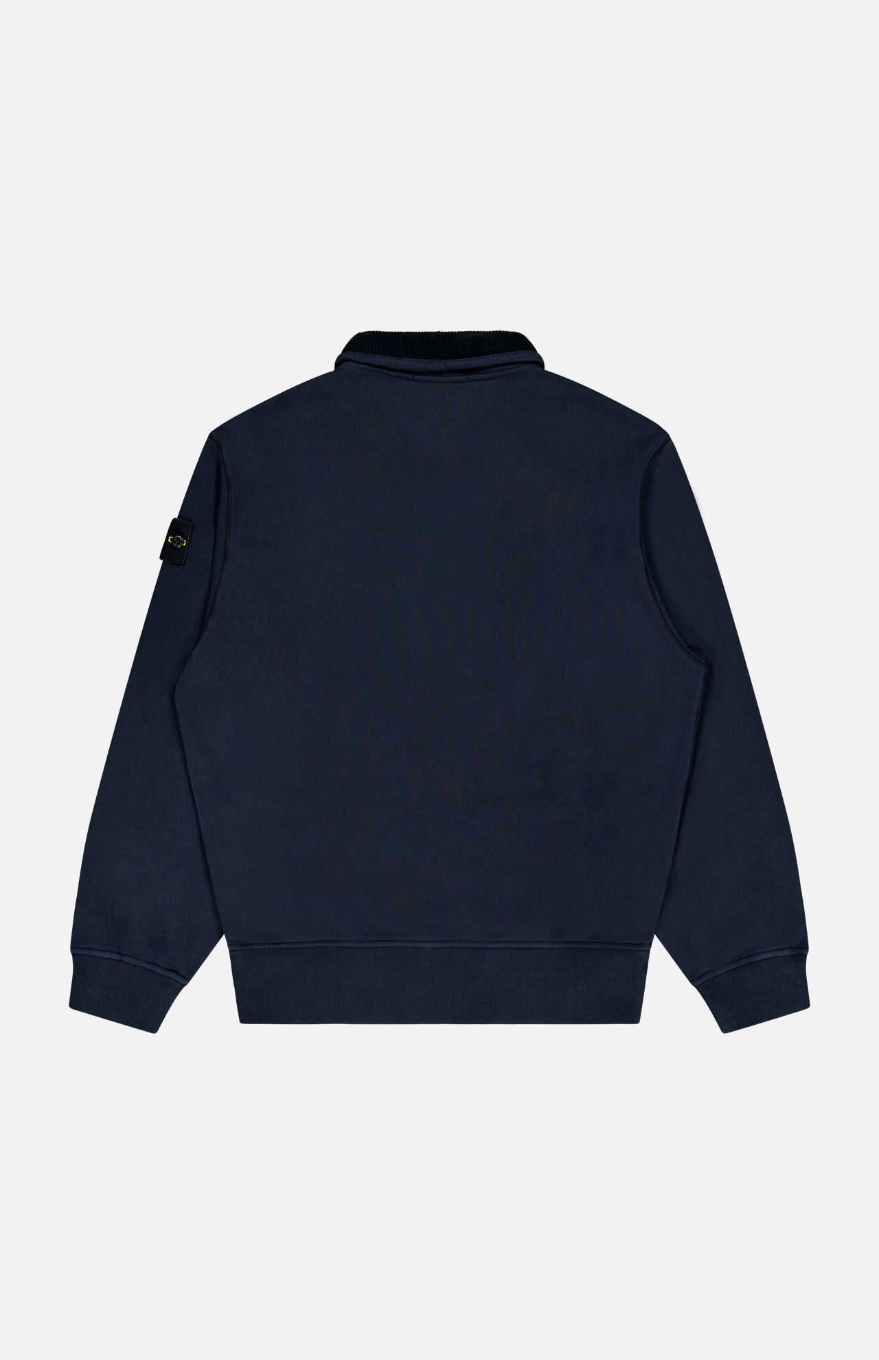 A STONE ISLAND Quarter Zip Sweatshirt in navy blue is displayed from the back, showcasing its long sleeves with ribbed cuffs and hem. The left sleeve features a small black patch with a yellow logo. Set against a plain white background, this sportswear staple stands out.