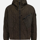 The Quilted Hooded Jacket by STONE ISLAND is crafted from stretch nylon in a dark olive green tone, featuring quilted detailing, a front zipper closure, an angled zippered chest pocket, a hood, ribbed cuffs, and a small logo patch on the left sleeve.