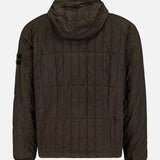 A STONE ISLAND Quilted Hooded Jacket in dark brown, featuring black cuffs, a signature logo patch on the left sleeve, and crafted from stretch nylon, is displayed from the back against a plain white background.