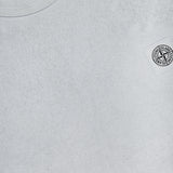 A close-up of the STONE ISLAND Reflected Short Sleeve T-Shirt, featuring a white color with detailed views of the collar and two signature logo patches—one at the neckline and one on the chest.
