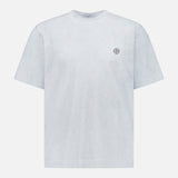 The STONE ISLAND Reflected Short Sleeve T-Shirt in light grey features a round neck and small circular chest logo—a minimalist streetwear staple, shown on a white background.