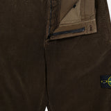 STONE ISLAND Regular-Fit Corduroy Trouser Pants in brown feature a partially open zipper and button, revealing the inner waistband, fly, and inner label. The signature Stone Island patch accents the pocket for premium men’s designer style.