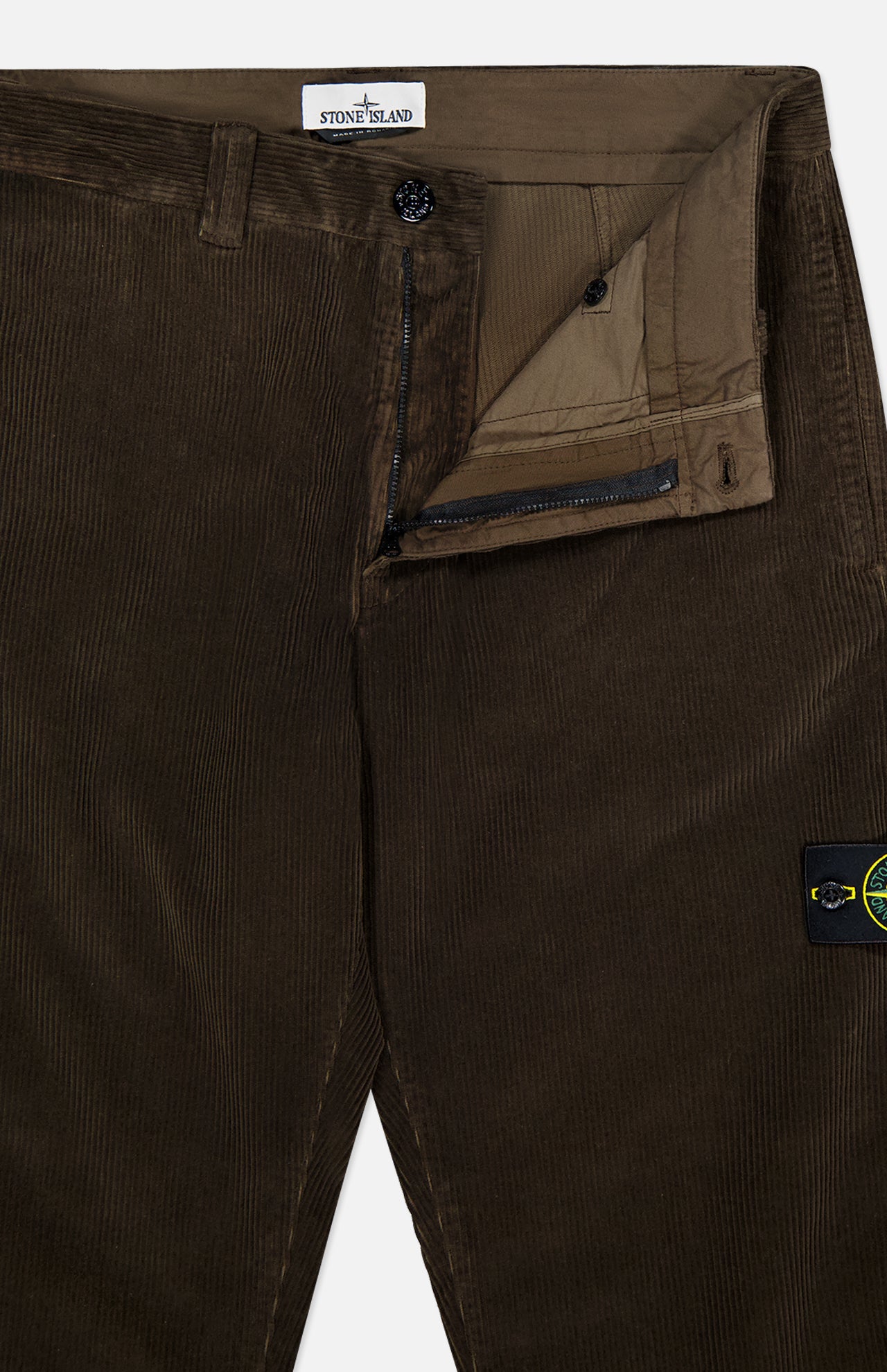 STONE ISLAND Regular-Fit Corduroy Trouser Pants in brown feature a partially open zipper and button, revealing the inner waistband, fly, and inner label. The signature Stone Island patch accents the pocket for premium men’s designer style.