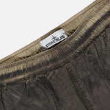 Close-up of the waistband of STONE ISLAND Regular-Fit Pattern Trousers in brown, showcasing the gathered elastic and brand label sewn inside, a detail that highlights the brand’s signature technical construction.