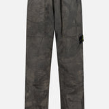 STONE ISLAND Regular-Fit Pattern Trousers in a brownish-grey shade, featuring loose fitting, an elastic waistband, side pockets, and a small black logo patch on the left leg, crafted with technical construction and shown against a plain white background.