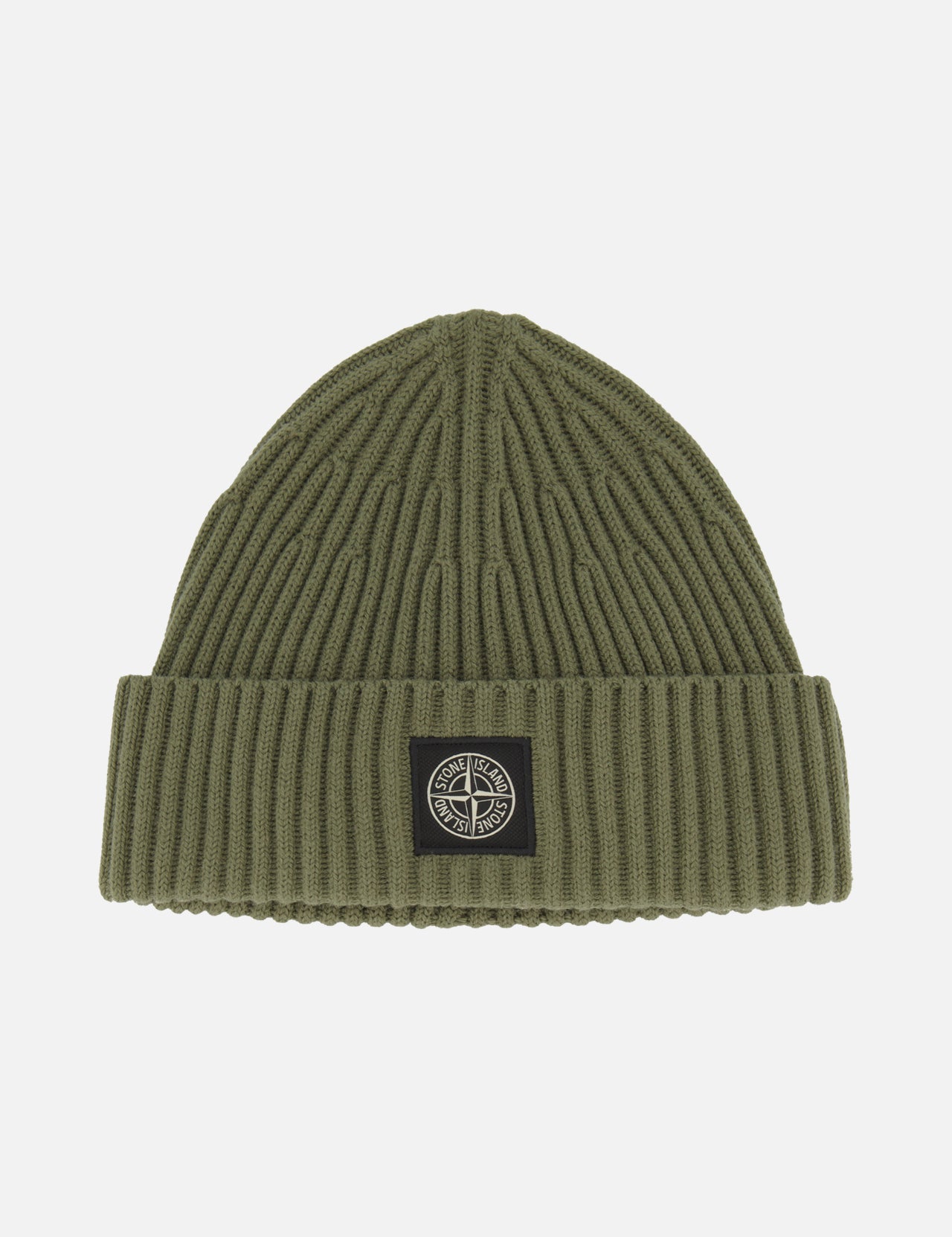 STONE ISLAND’s Ribbed Wool Beanie in olive green features a folded brim and showcases a black and white circular logo patch at the front center. This classic military green accessory stands out against a plain white background.