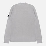 The STONE ISLAND Ribbed Crewneck Sweater is light gray with long sleeves and a black tag on the left upper sleeve. Seen from the back against a plain white background.