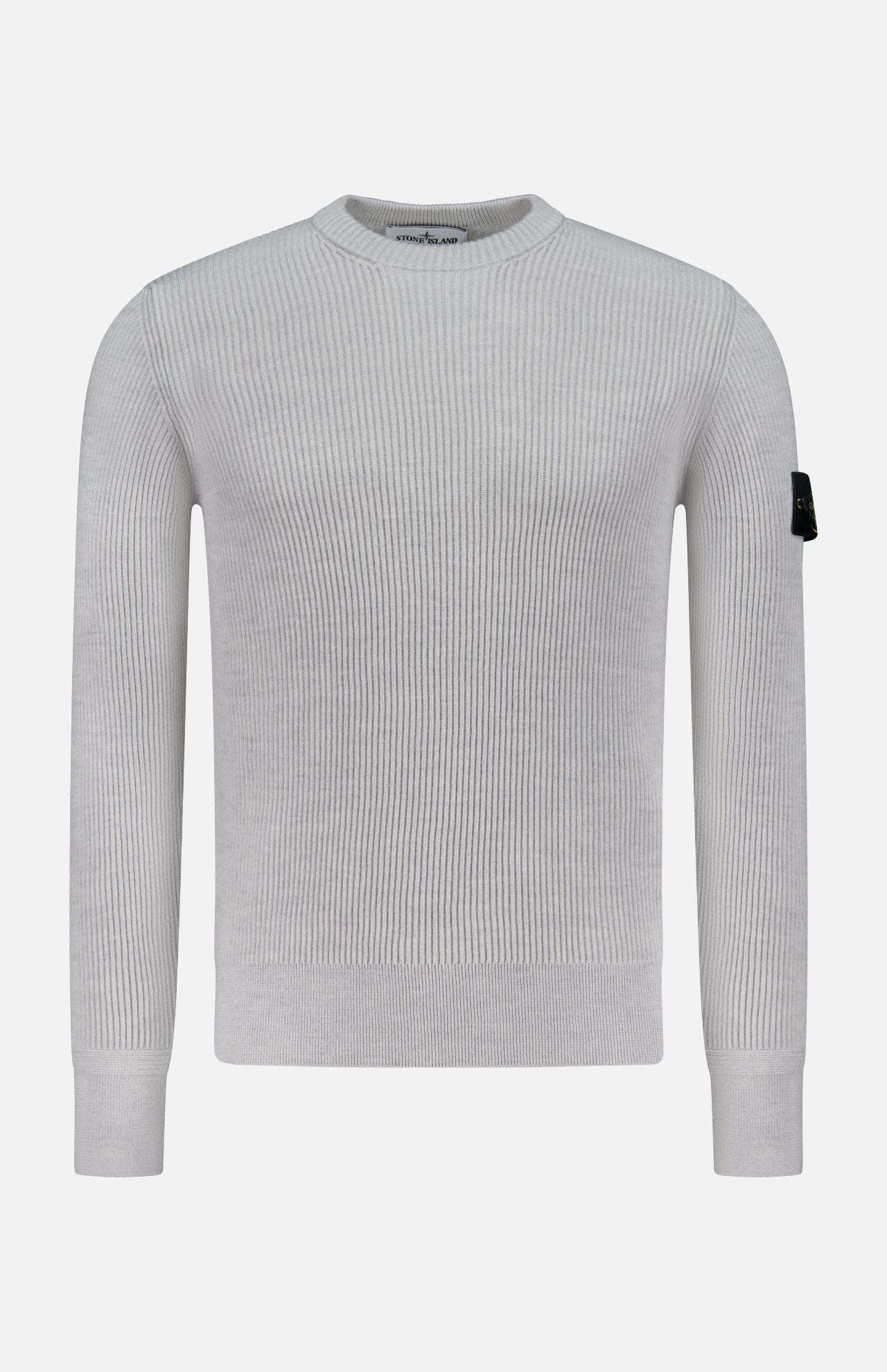 The STONE ISLAND Ribbed Crewneck Sweater in light grey features long sleeves, a ribbed knit design, and a black patch with the circular logo on the upper left sleeve. Shown on a plain white background.