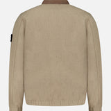 A STONE ISLAND Stand Collar Zip Up Jacket in beige is displayed from the back against a plain white background. The jacket features long sleeves, a brown collar, and a relaxed fit, with the iconic patch logo on the left sleeve that reflects contemporary streetwear style.