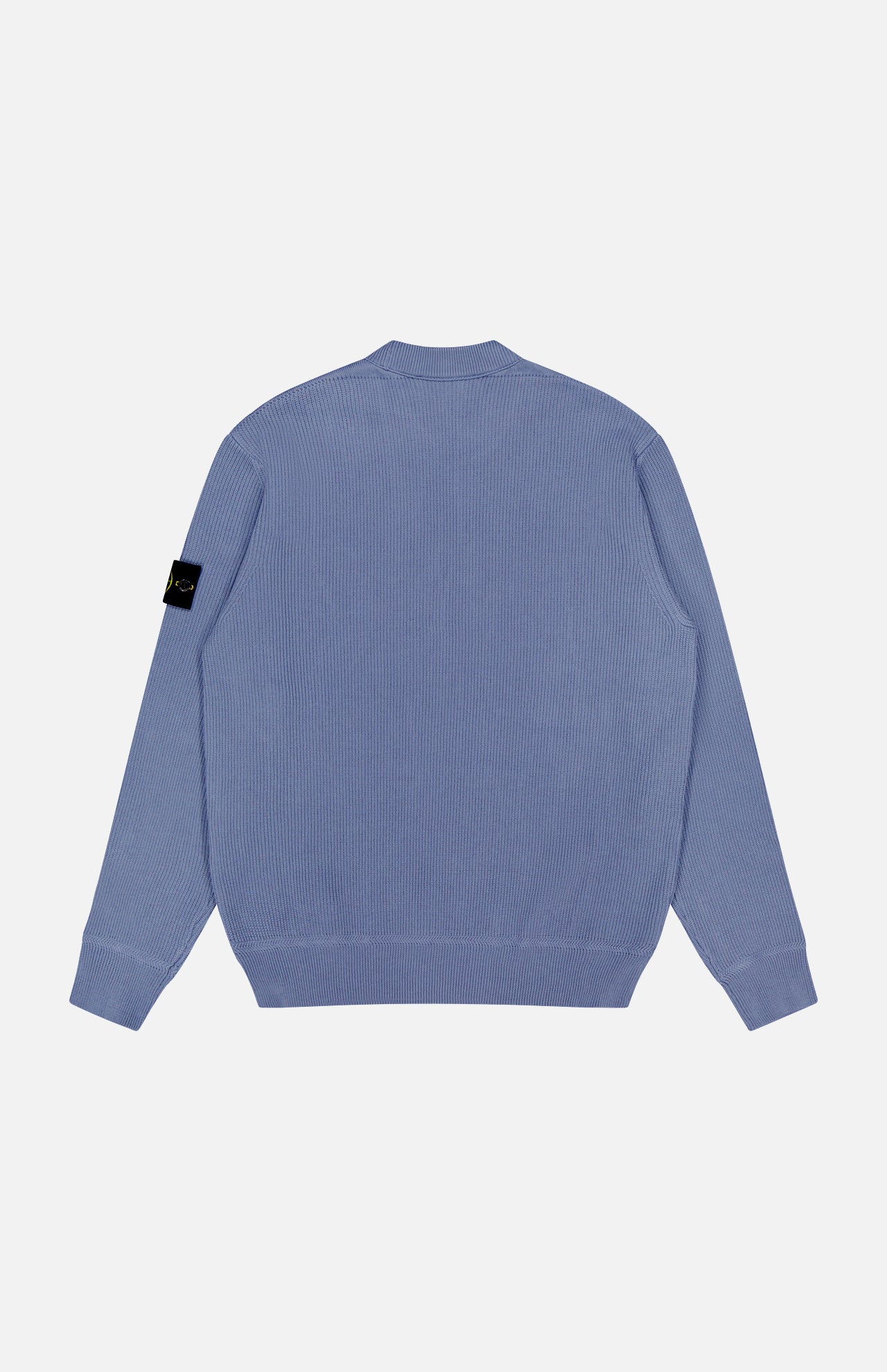The STONE ISLAND Ribbed Knit Crewneck Sweater in light blue cotton features ribbed cuffs and hem, a back view, and the signature black patch with yellow logo on the left sleeve—perfect for men's sportswear collections.