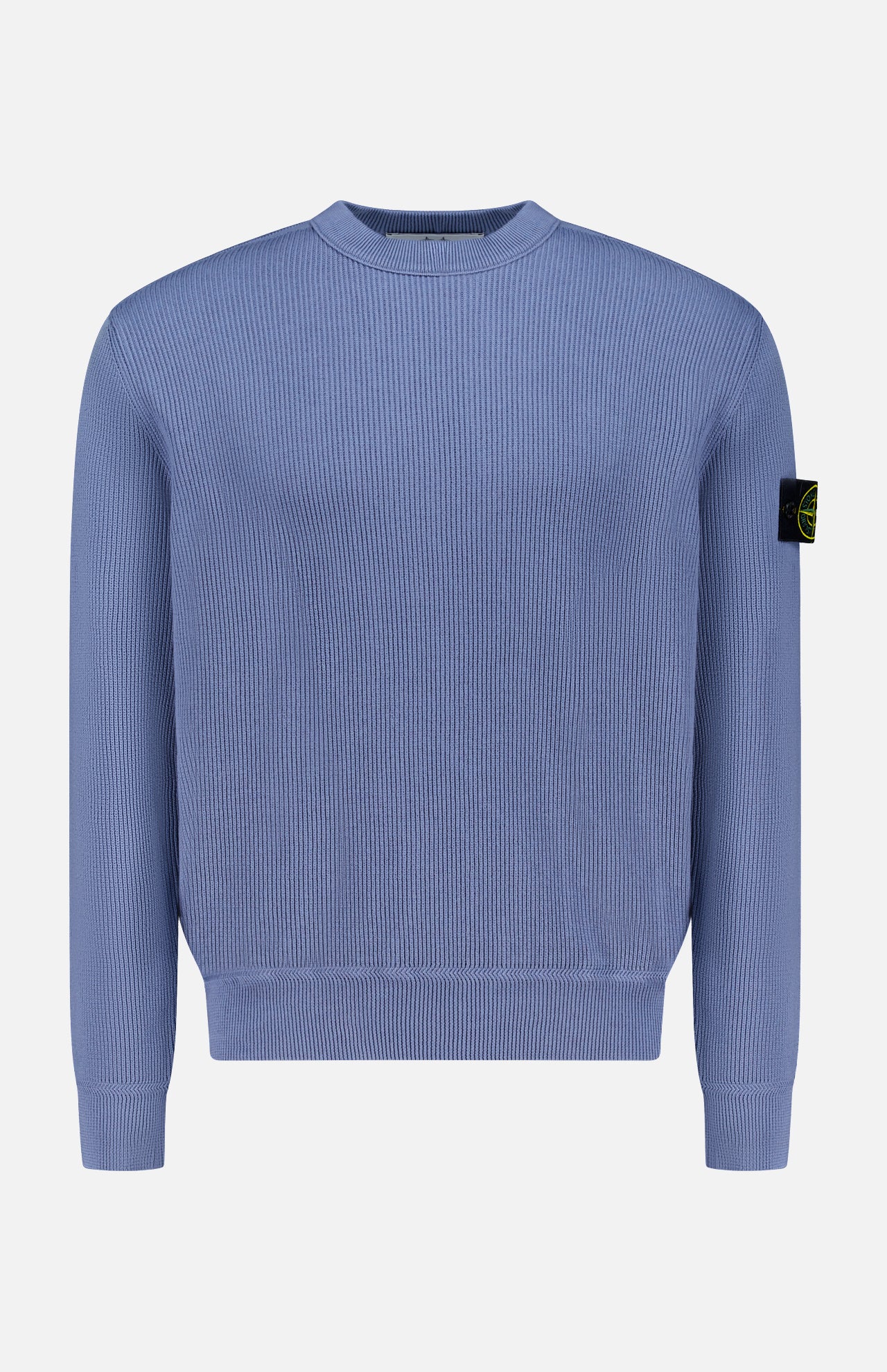 The STONE ISLAND Ribbed Knit Crewneck Sweater in light blue cotton features a ribbed design, crew neck, and signature black patch with yellow emblem on the upper left sleeve—ideal for men’s sportswear collections.