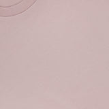 A close-up of the SUNSPEL Classic Short Sleeve T-Shirt in pale pink, showcasing its soft 100% cotton fabric, round collar, and visible brand label inside the neckline.