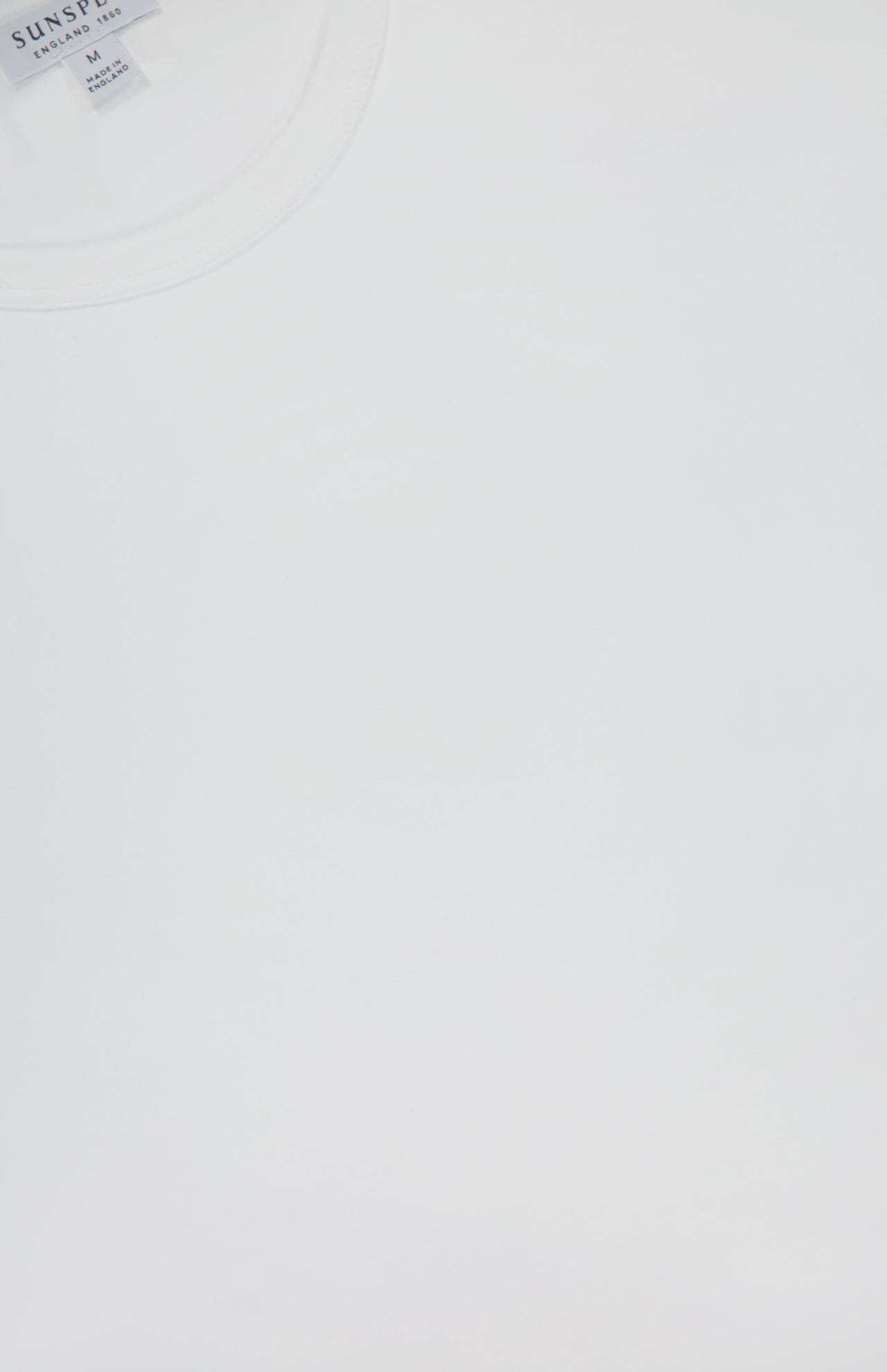 A close-up of the SUNSPEL Long Sleeve Classic T-Shirt shows part of the collar and tag in the upper left corner, set against a white background.
