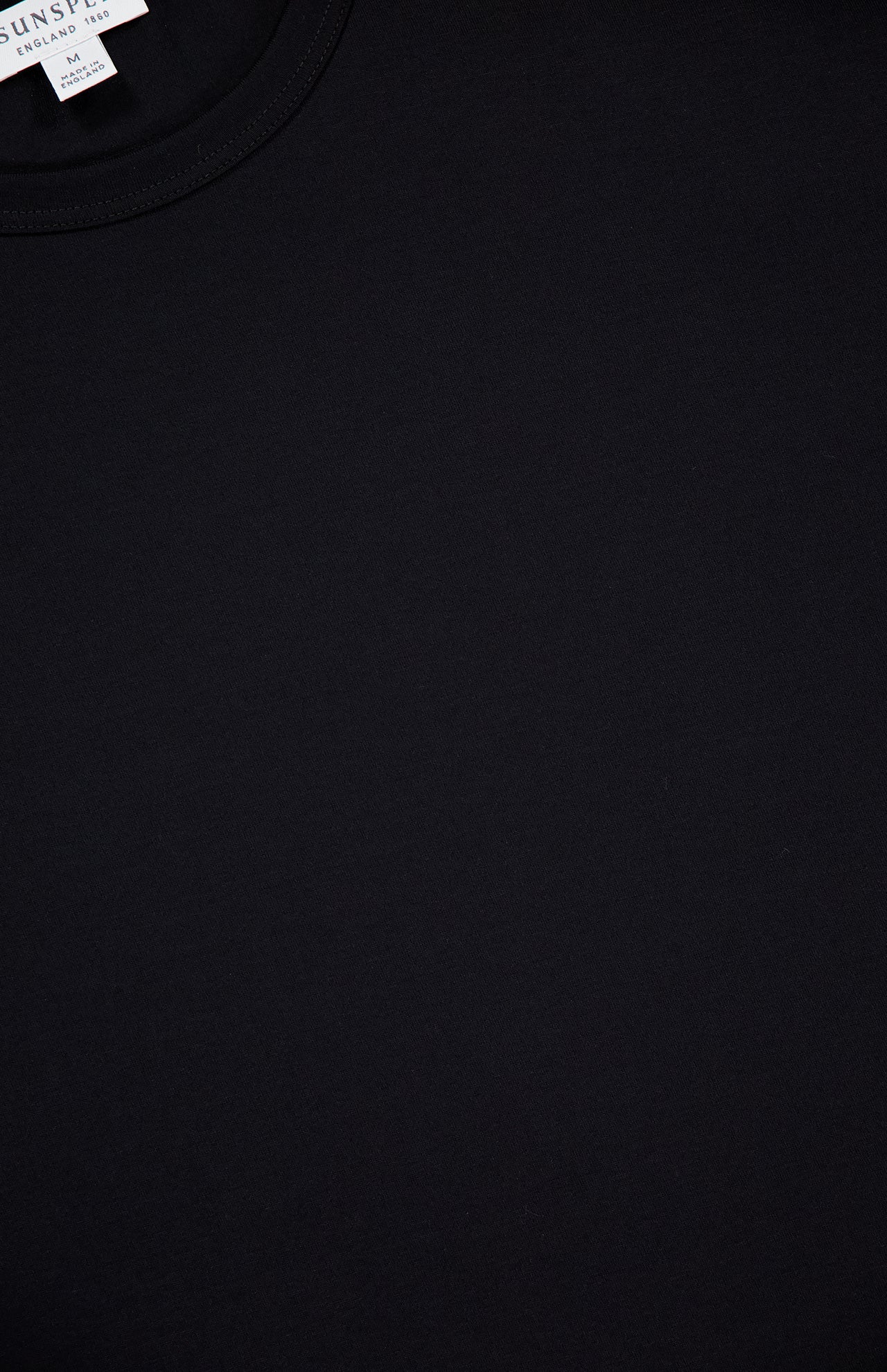 Close-up of the SUNSPEL Short Sleeve Classic Crewneck T-Shirt in black, featuring a visible neck seam and a small white label near the collar—an iconic 100% cotton tee.