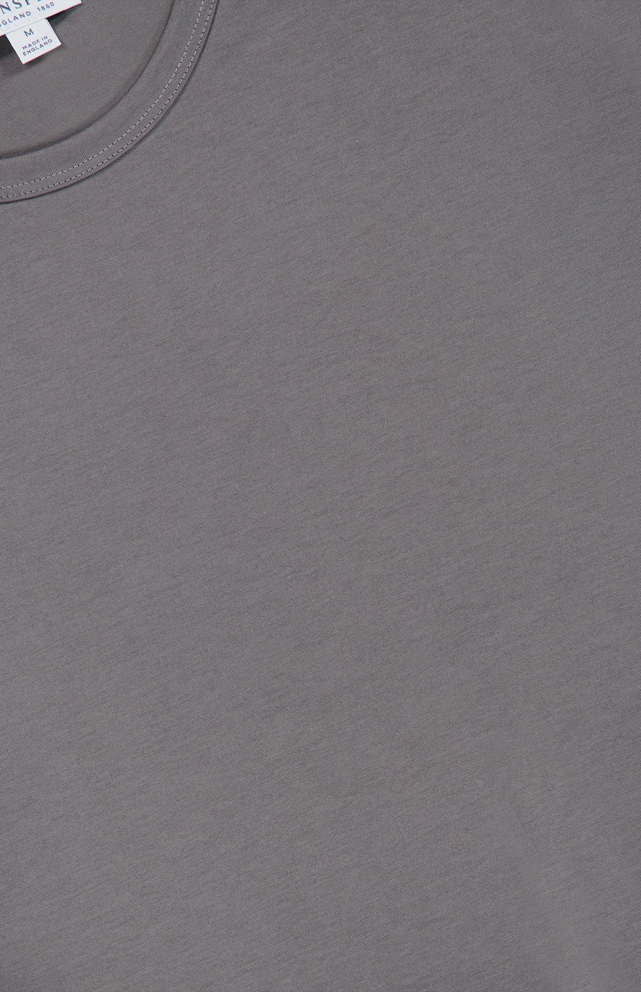 A close-up of the SUNSPEL Short Sleeve Classic T-Shirt in grey, showcasing the neckline and part of the fabric’s smooth texture. Crafted in England from 100% cotton, this t-shirt exemplifies exceptional quality and craftsmanship.