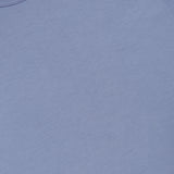 A close-up of the SUNSPEL Short Sleeve Classic T-Shirt in light blue cotton, highlighting the collar and part of the tag. Made in England, this timeless tee has a simple, understated style with no visible designs or patterns.