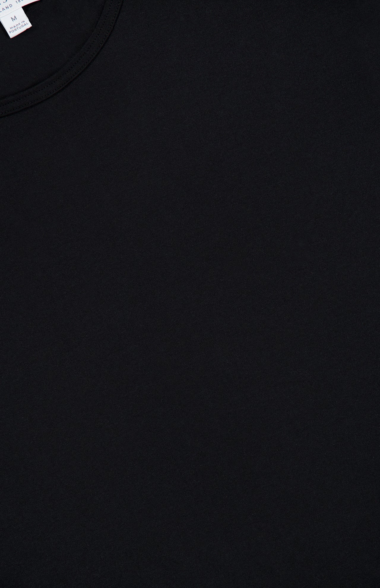 Close-up of the SUNSPEL Superfine Underwear T-Shirt in plain black, highlighting the crew neck and a small portion of a white label at the upper left. Made from premium long staple cotton, this essential piece is an ideal addition to men’s loungewear collections.