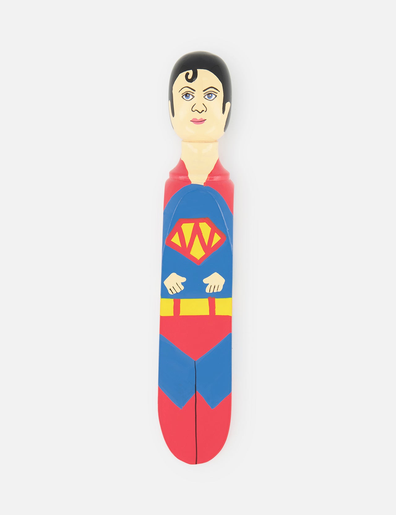 The WEDGIE ‘Super Wedgie’ Wood Door Stopper is a hand-painted doorstop featuring a superhero in a red, blue, and yellow costume with a cape and S emblem, inspired by Superman, shown on a plain white background.