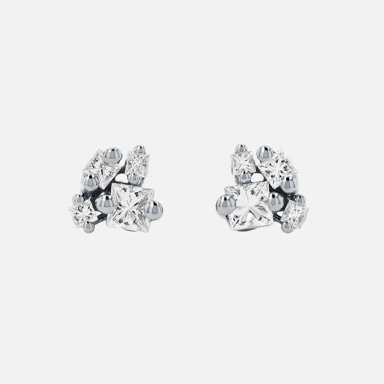 The SUZANNE KALAN 18KW Princess Diamond Cluster Stud Earrings feature five clear diamonds in varied shapes and sizes, artfully clustered together on 18k white gold studs, shown against a plain white background.