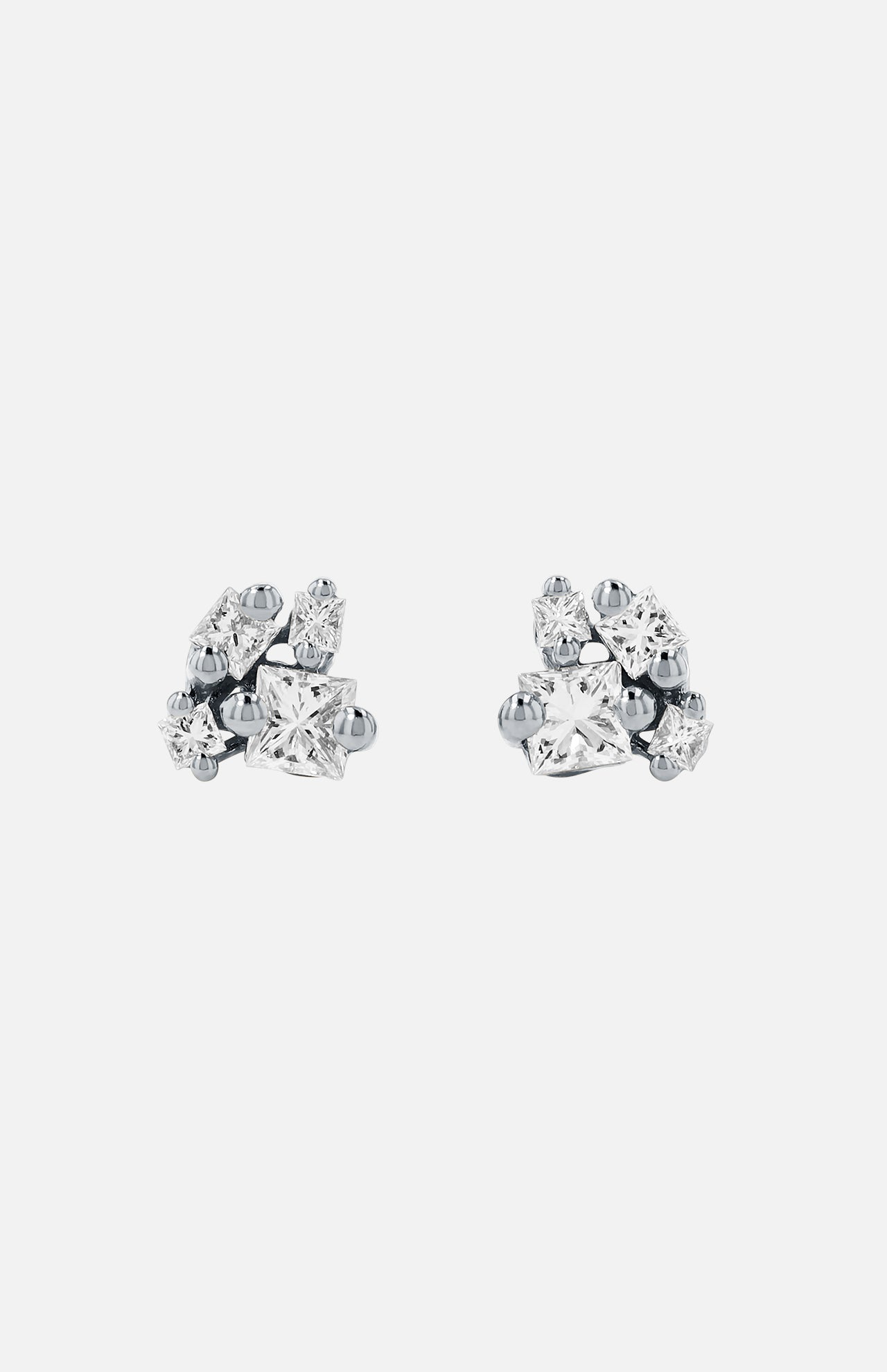The SUZANNE KALAN 18KW Princess Diamond Cluster Stud Earrings feature five clear diamonds in varied shapes and sizes, artfully clustered together on 18k white gold studs, shown against a plain white background.