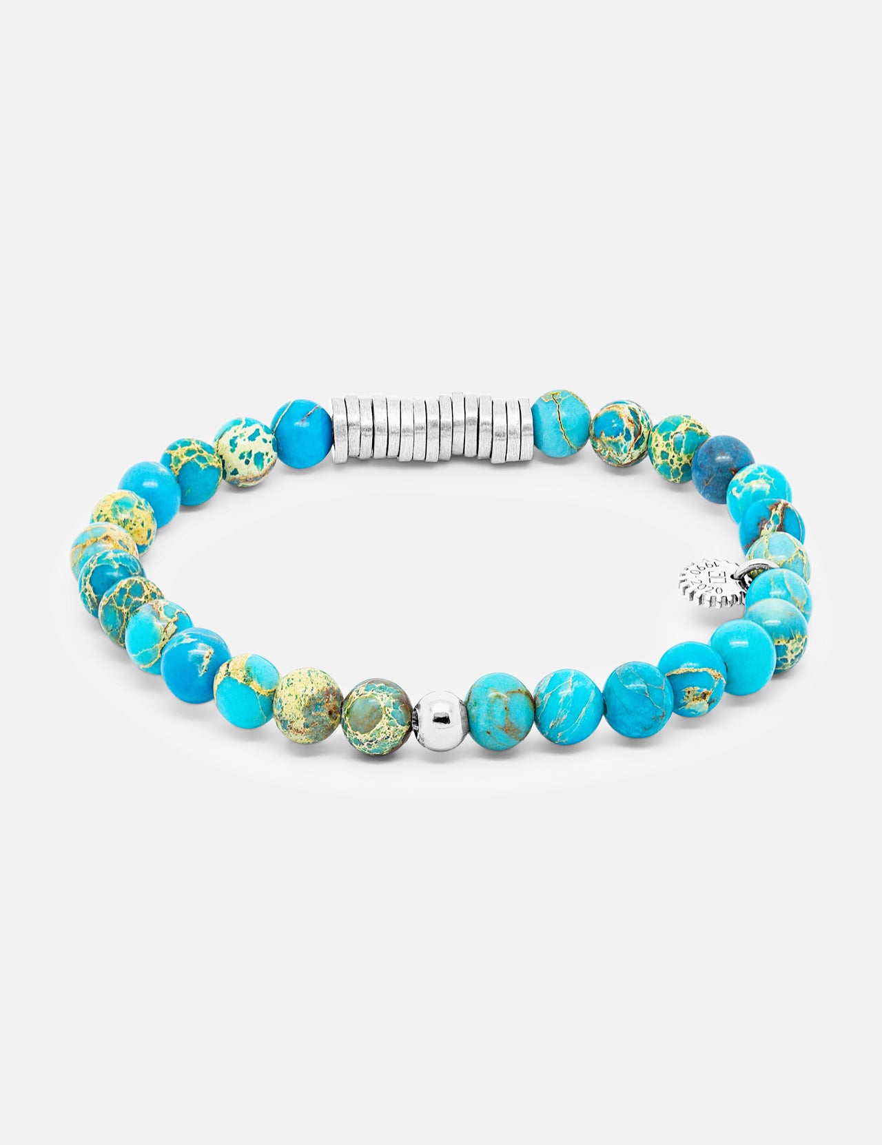 The TATEOSSIAN Classic Discs Beaded Bracelet features turquoise and green marbled stones, silver-toned spacer beads, and a small silver charm—an elegant handcrafted gemstone accessory.