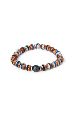The TATEOSSIAN Lhasa Graffiato Bracelet features round, multicolored agate beads in blue, brown, and white with a textured black centerpiece, inspired by Tibetan Dzi styles, arranged in a circle on a white background.