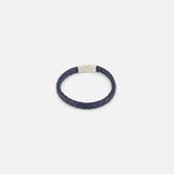 The TATEOSSIAN Giza Double Click Pelle Bracelet, featuring navy braided leather and a sterling silver cylindrical clasp, is displayed on a plain white background.