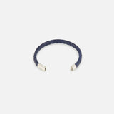 The TATEOSSIAN Giza Double Click Pelle Bracelet, featuring navy braided leather and sterling silver end caps in a stylish open-ended C-shape, is displayed on a plain white background.