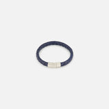 The TATEOSSIAN Giza Double Click Pelle Bracelet, featuring navy braided leather and a sterling silver cylindrical clasp, is displayed on a plain white background.