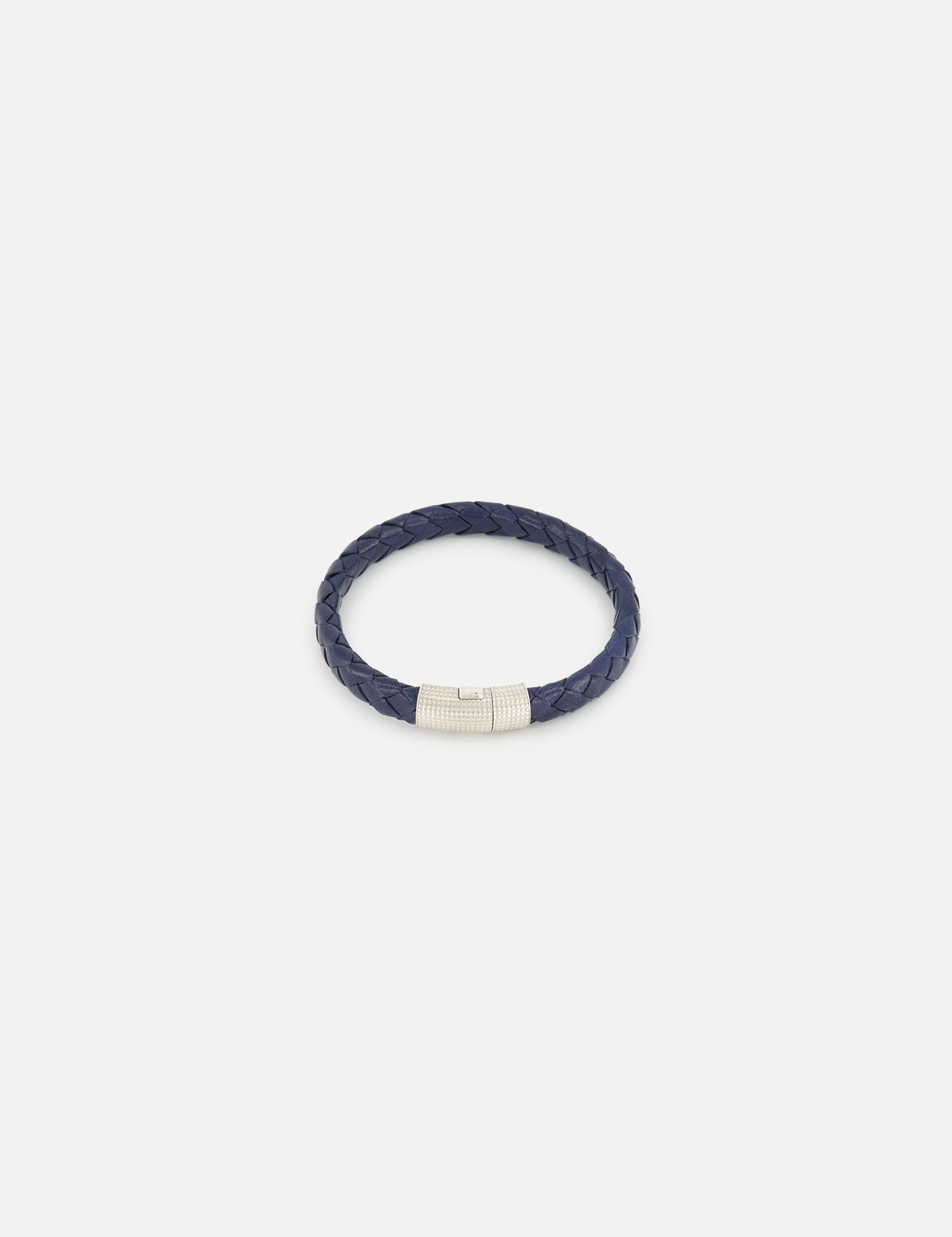 The TATEOSSIAN Giza Double Click Pelle Bracelet, featuring navy braided leather and a sterling silver cylindrical clasp, is displayed on a plain white background.