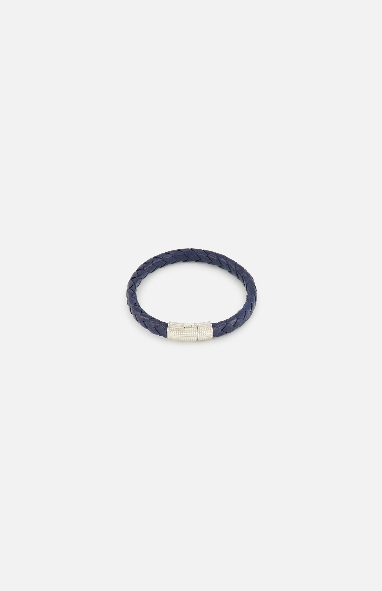 The TATEOSSIAN Giza Double Click Pelle Bracelet, featuring navy braided leather and a sterling silver cylindrical clasp, is displayed on a plain white background.