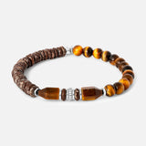 Tateossian Totem Disc Bracelet featuring a row of dark brown obsidian textured discs, two geometric tiger eye beads, a central ridged silver-tone spacer, and a string of round tiger eye beads.