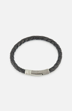 The TATEOSSIAN Vintage Herringbone Click Bracelet features black braided leather and a stainless steel clasp, shown on a plain white background.