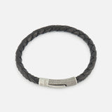 The TATEOSSIAN Vintage Herringbone Click Bracelet is a men’s luxury accessory with black braided leather and a textured stainless steel clasp, showcased elegantly on a plain white background.