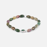 The TATEOSSIAN Indian Jasper Viper Bracelet showcases green, brown, and purple oval stones with a silver spider web charm at the center, creating a unique luxury accessory.