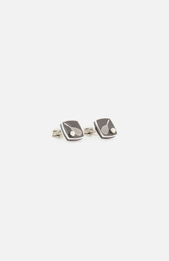 A pair of TATEOSSIAN Polished Enamel Tennis Cufflinks with square, silver-toned stainless steel and dark textured faces featuring a small round detail—ideal for adding luxury to any formalwear. Displayed on a white background.
