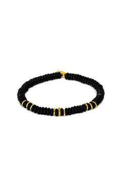 The TATEOSSIAN Positano Beaded Bracelet features small round black agate beads accented with evenly spaced gold cylindrical beads and finished with a yellow gold plated clasp.
