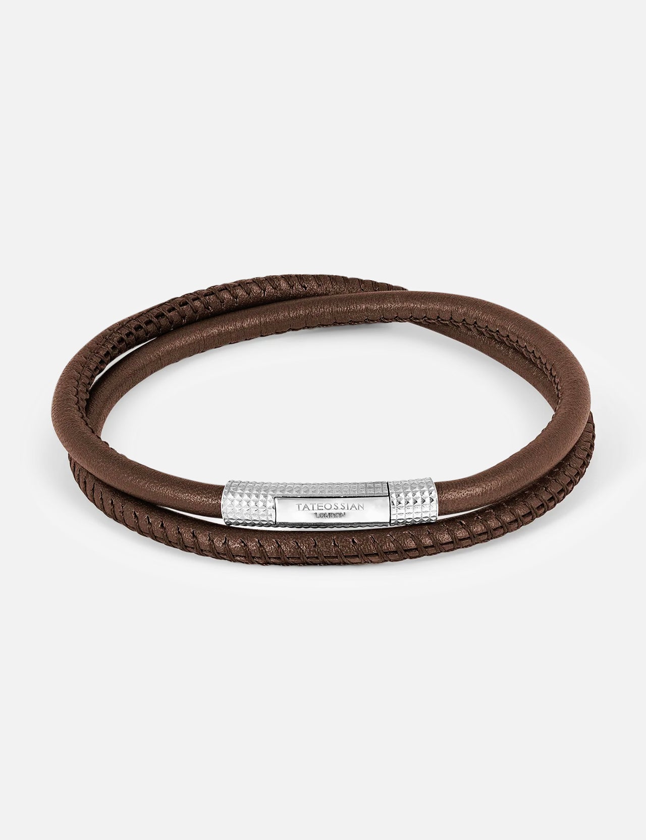 The TATEOSSIAN Rhodium & Leather Bracelet showcases a double-wrap brown leather band and a textured rhodium-plated clasp engraved with the brand logo, displayed on a white background.