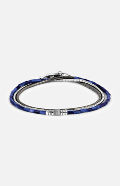 The TATEOSSIAN Navajo Triple Wrap Beaded Bracelet features triple strands of alternating silver and blue rectangular beads with a metallic clasp, showcased against a plain white background.