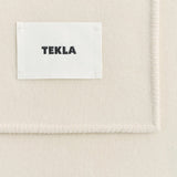 Off-white Lambswool Blanket with a stitched edge and a white TEKLA label in black text.