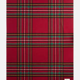 TEKLA Lambswool Fringed Blanket in red plaid with green, yellow, and black stripes and a fringed edge.