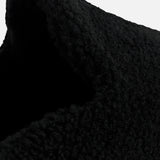 Close-up of a black textured TEKLA Shearling Slipper with a cushioned footbed.