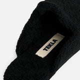 Black TEKLA Shearling Slippers with a cushioned footbed and a branded interior label.