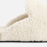 Close-up of a cream-colored TEKLA Shearling Slipper with a cushioned footbed and a dark sole.