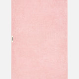 A light pink TEKLA Terry Bath Towel in organic cotton with a small branded label on the left edge.