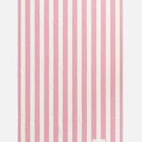 A rectangular pink TEKLA Terry Beach Towel with white vertical stripes and fringe at both ends.
