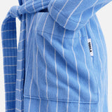 TEKLA Terry Classic Unisex Bathrobe in blue and white stripes, featuring a tie belt and a front pocket with a logo tag.